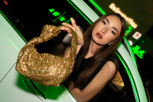 Gold sequin bow shoulder bag with top handle