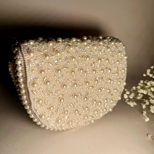 Pearl beaded clutch with curved top and heart-like silhouette