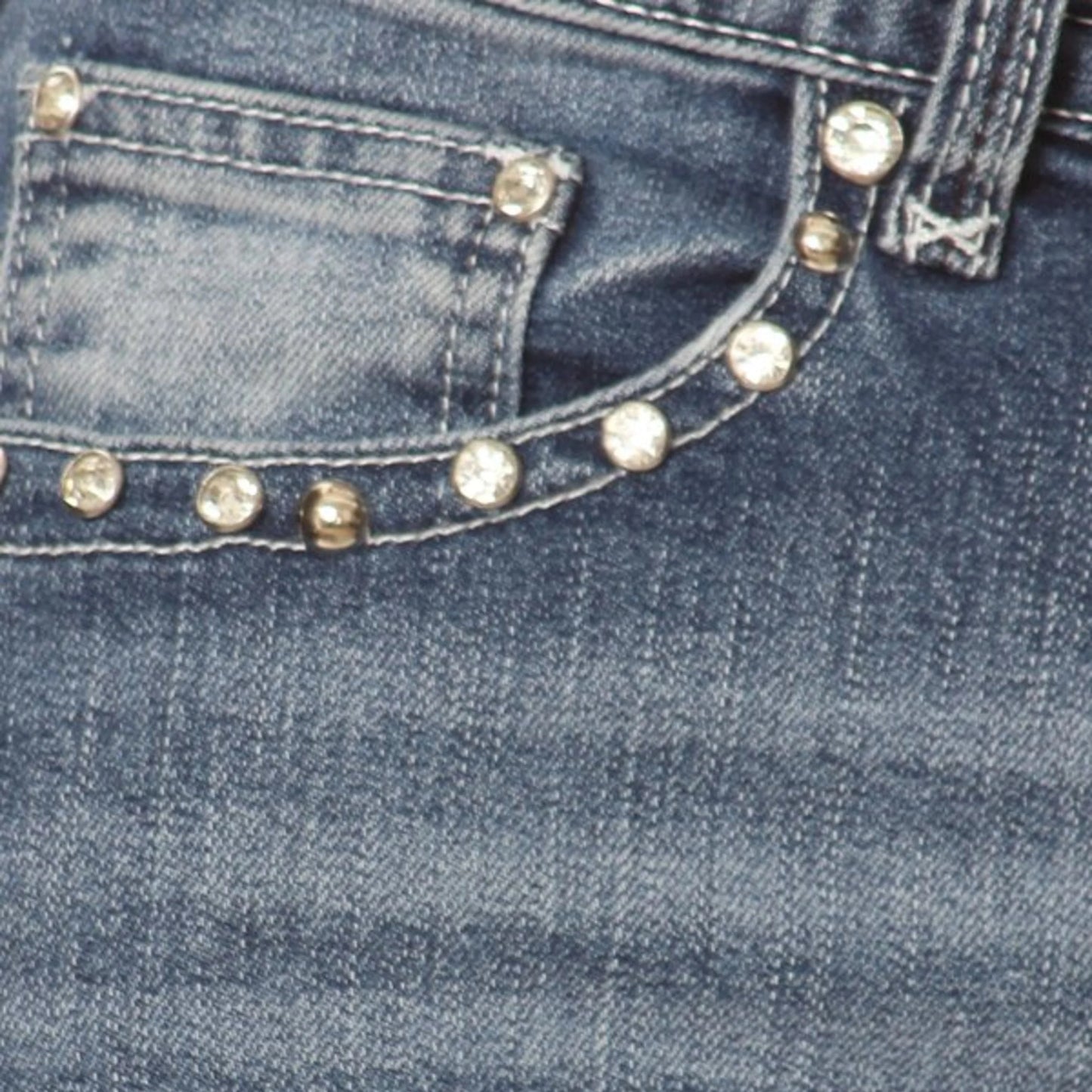 Women's denim jeans front pocket with gold-tone stud trim along seams