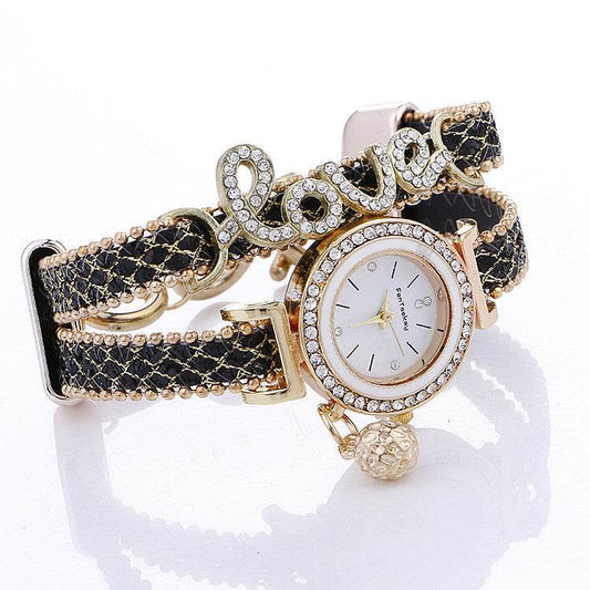 Rhinestone bracelet watch with round white dial, gold-tone bezel, and black leather strap