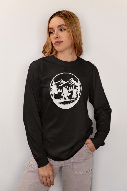 Black long-sleeve T-shirt with circular Bigfoot forest graphic on front