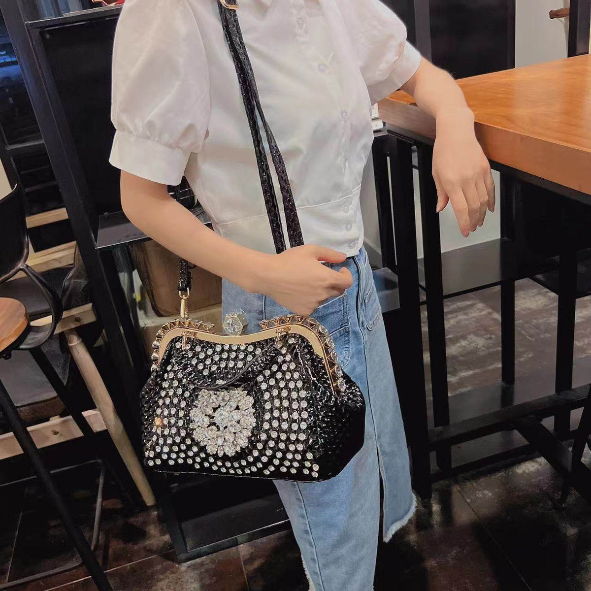 Diamond-inlaid crossbody handbag for women, white with crystal flower center and strap.