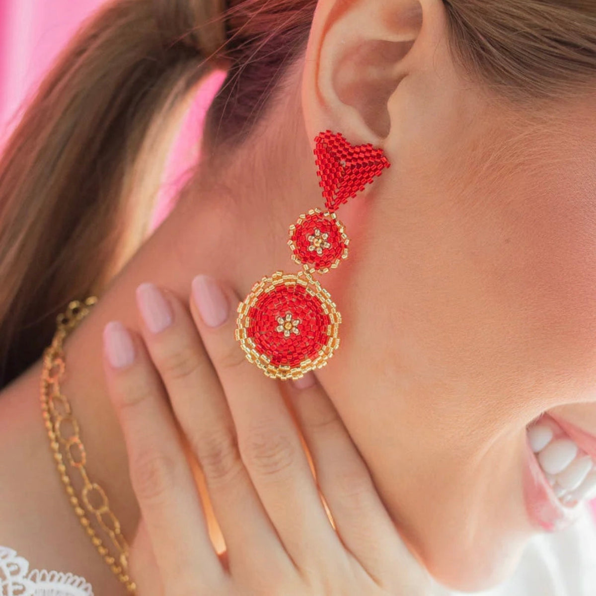 Red beaded drop earrings with heart and circular charm