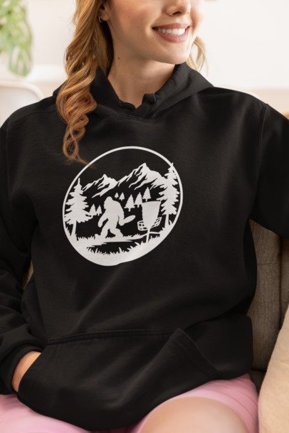 Black hoodie with circular Bigfoot forest graphic and front pouch pocket
