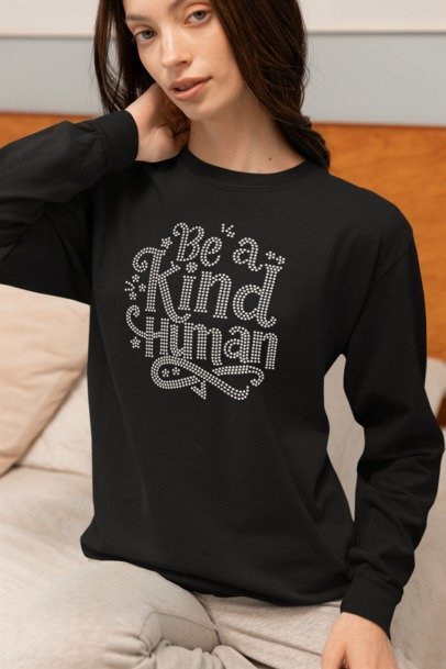 Woman wearing black rhinestone "Be a Kind Human" crewneck sweatshirt – Inspirational Bling Apparel by Blingdazzel