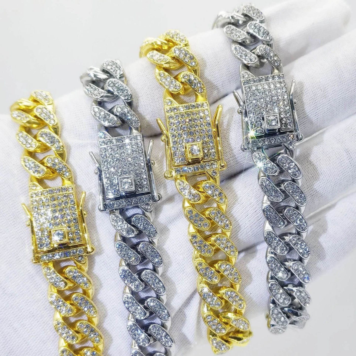Set of gold and silver diamond Cuban link bracelets with rectangular clasps.