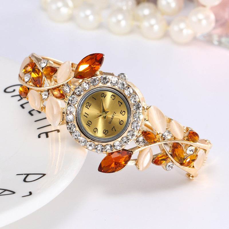 Gold-tone ladies bracelet watch with amber stones and crystal bezel round dial