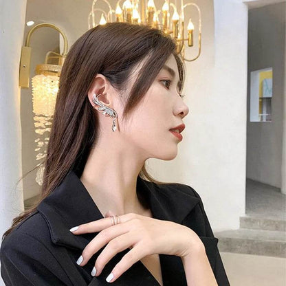 Silver angel wing ear bone clip earrings with teardrop dangling stones on ear