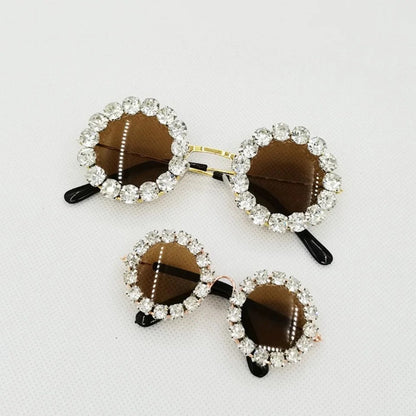 Silver rhinestone pet sunglasses with oval brown tinted lenses and black temple tips
