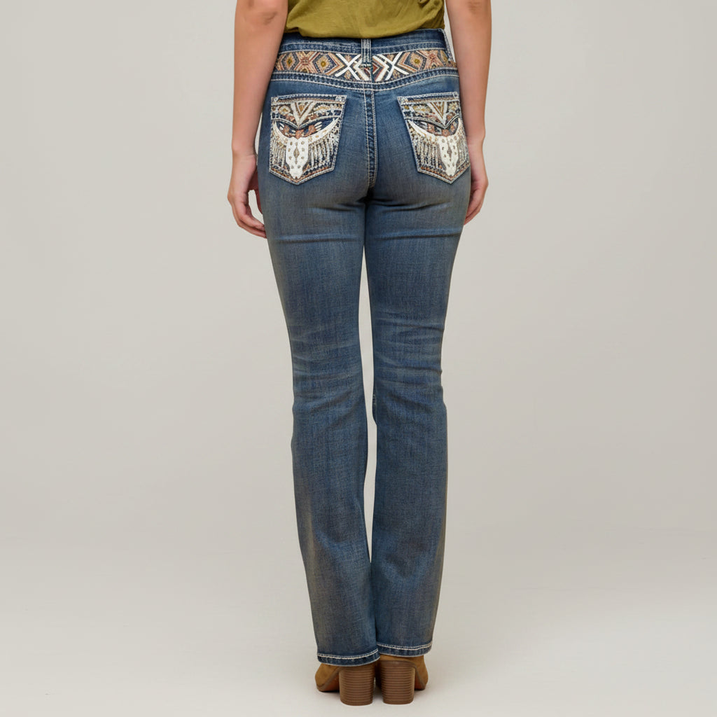 Blue embroidered bootcut jeans with ornate back yoke pocket detail.