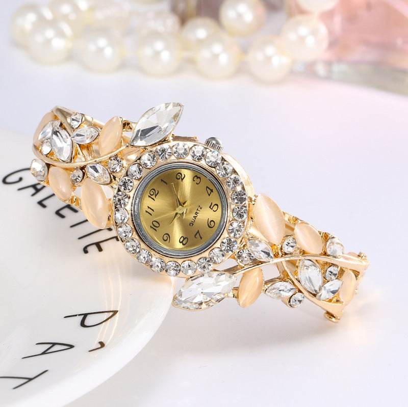 Gold-tone ladies bracelet watch with clear stones and crystal bezel round dial