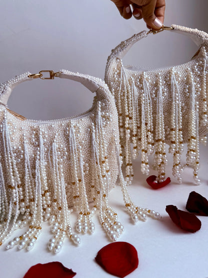 White pearl fringe evening clutch bag with gold-tone top handle and clasp