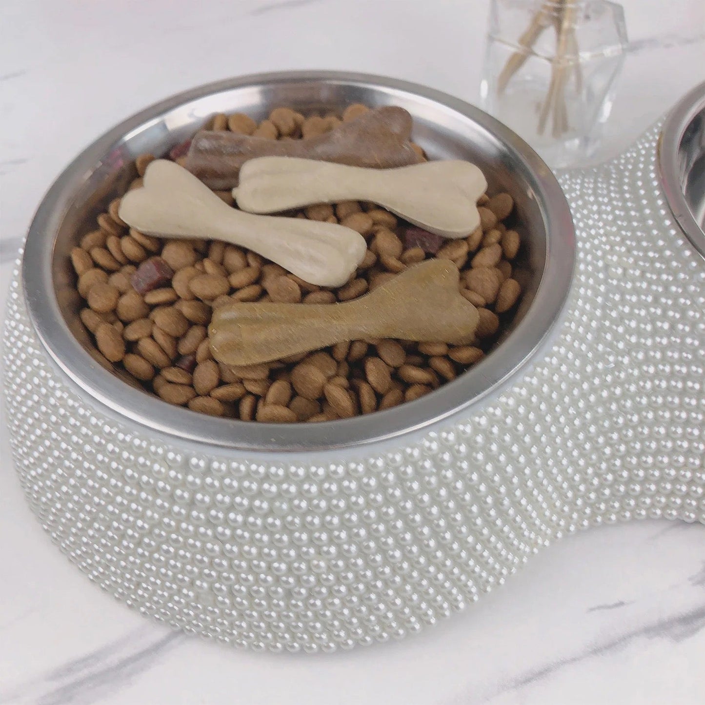 Silver rhinestone dog bowl with stainless steel insert filled with kibble
