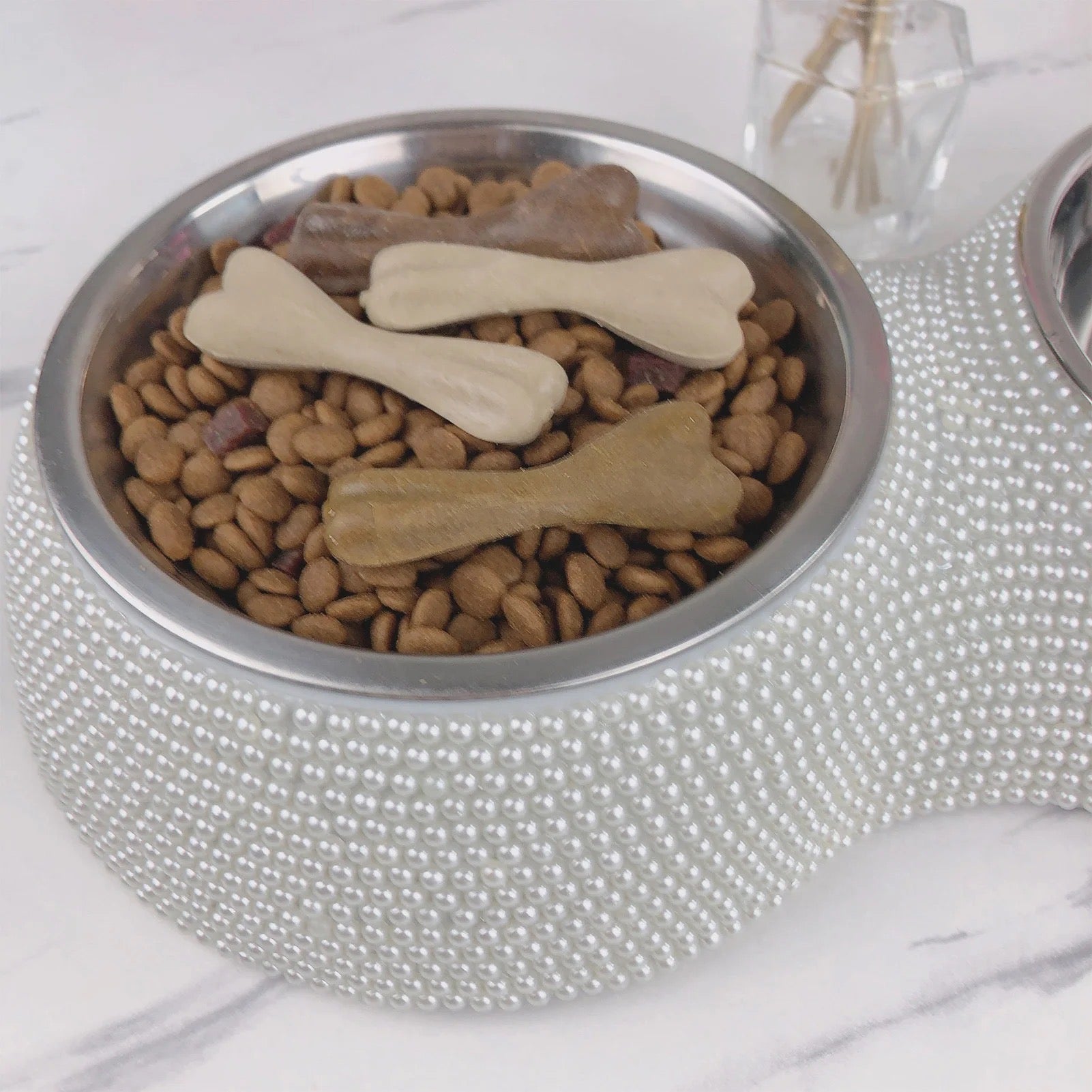 Silver rhinestone dog bowl with stainless steel insert filled with kibble