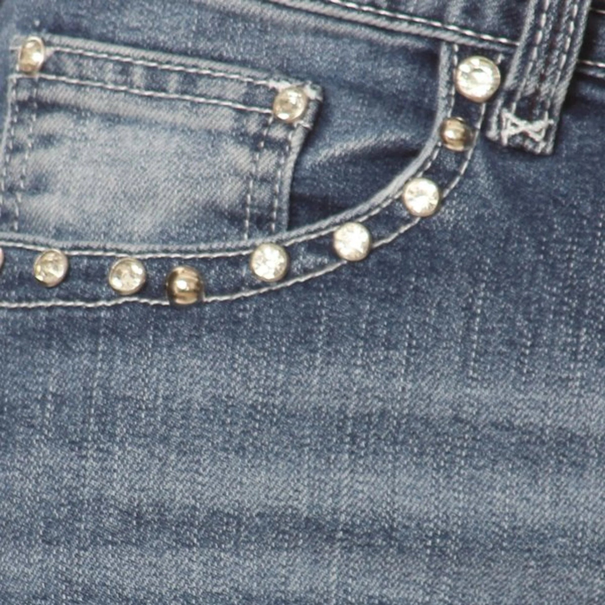Women's denim jeans front pocket with gold-tone stud trim along seams