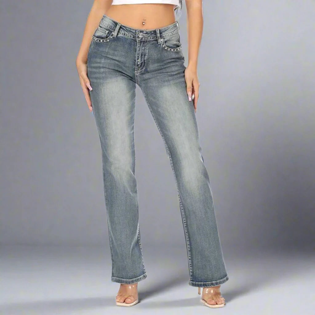 Women's bootcut jeans in light blue denim wash with front pockets and belt loops