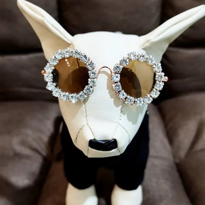 White pet sunglasses with rhinestone frames and dark oval lenses, butterfly temples