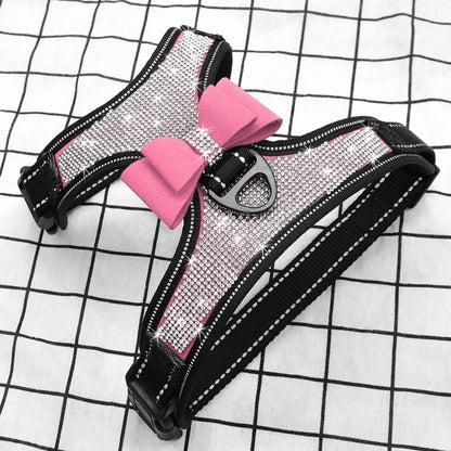 Pink rhinestone dog harness with bow detail and black adjustable straps