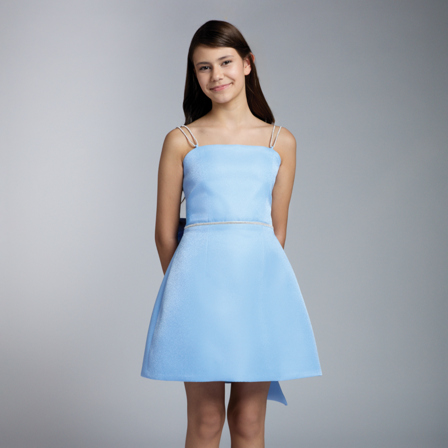 Blue girls formal dress with spaghetti straps, fitted waist, and flared skirt