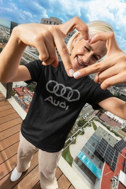 Person wearing an Audi t-shirt with a cityscape in the background