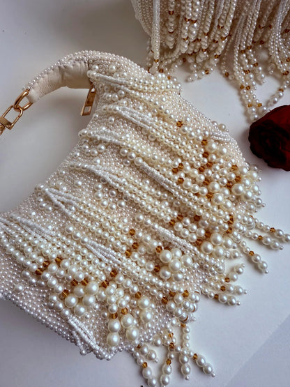 White pearl beaded clutch bag with tassel fringe and gold-tone accents