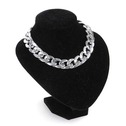 Silver-tone chain dog necklace on a black display bust
