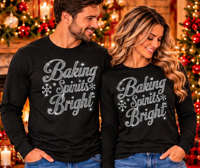 Black long-sleeve shirt with silver rhinestone “Baking Spirits Bright” lettering and snowflakes
