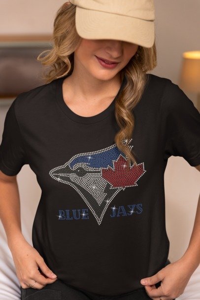 Person wearing a black t-shirt with a Blue Jays logo
