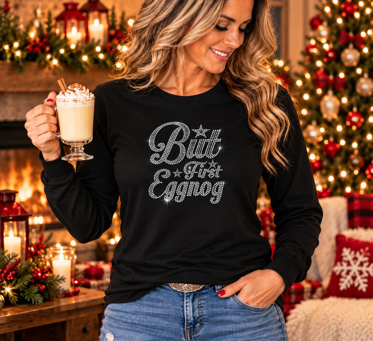 Black long-sleeve T-shirt with silver rhinestone “But First Eggnog” lettering