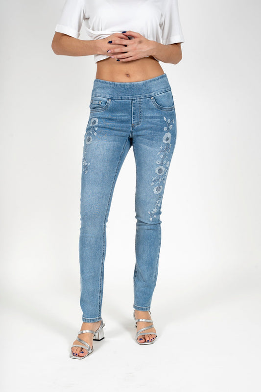 Light blue denim skinny jeans with floral rhinestone embroidery on leg
