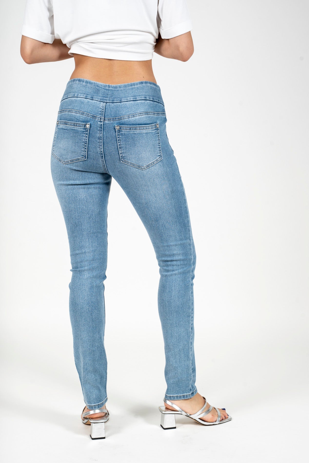 Light blue denim skinny jeans with back pockets and floral embroidery