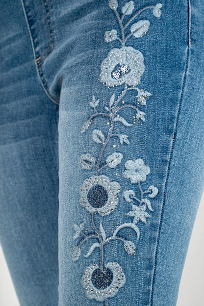 Light blue denim close-up with rhinestone floral pattern applique