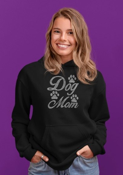 Woman wearing a black hoodie with 'Dog Mom' text on a purple background
