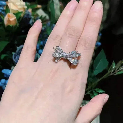 Diamond bow ring in silver-tone, multi-stone ribbon bow on finger