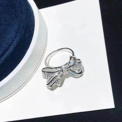 Silver-tone diamond bow ring on jewelry card, ribbon bow with prong-set stones