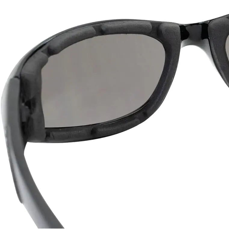 Black motorcycle sunglasses close-up of dark tinted lens and glossy frame edge