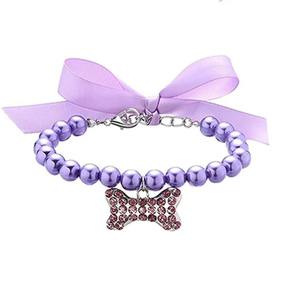 Purple pearl rhinestone dog collar with lavender ribbon bow and bone charm