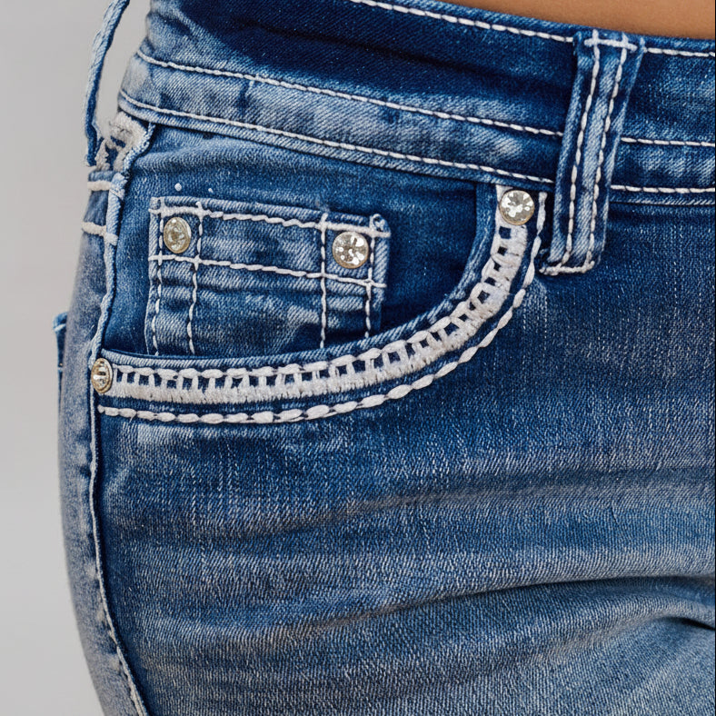 Women’s blue denim shorts detail: stitched front pocket with small rhinestone studs