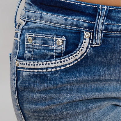 Women’s blue denim shorts detail: stitched front pocket with small rhinestone studs