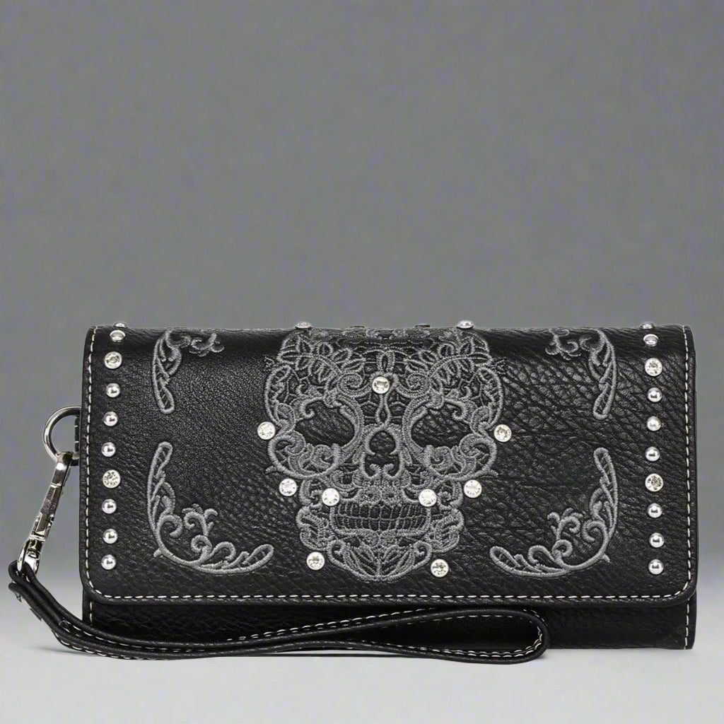 Faux leather trifold wallet with black base, white skull motif, and crossbody strap