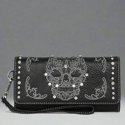 Faux leather trifold wallet with black base, white skull motif, and crossbody strap