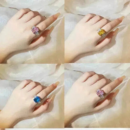 Crystal rings on fingers: pink, yellow, and blue square-cut stones on silver bands