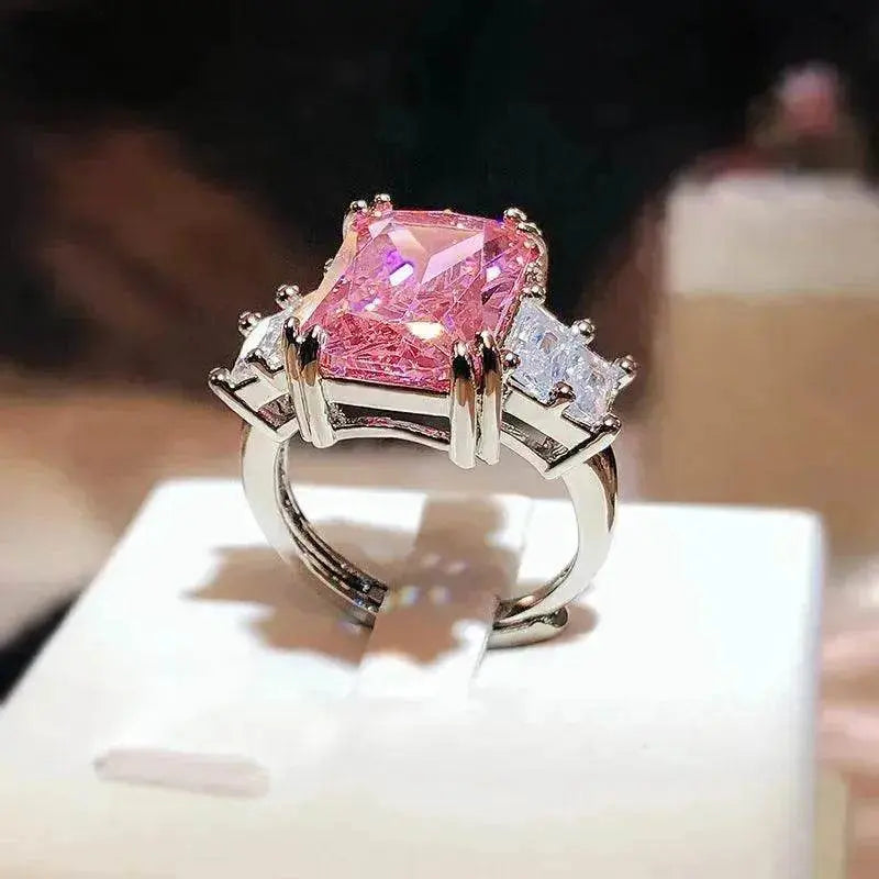 Pink square-cut crystal ring with silver band and rhinestone side stones