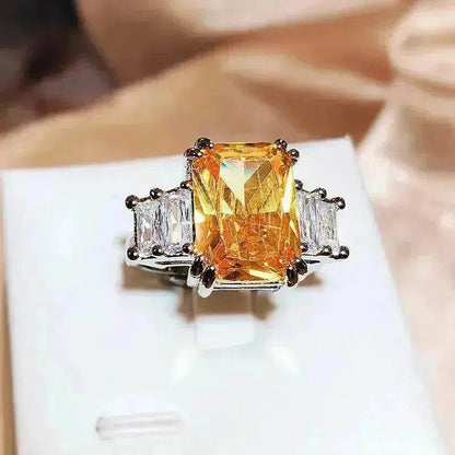 Yellow-orange square-cut crystal ring with silver band and prong-set stones