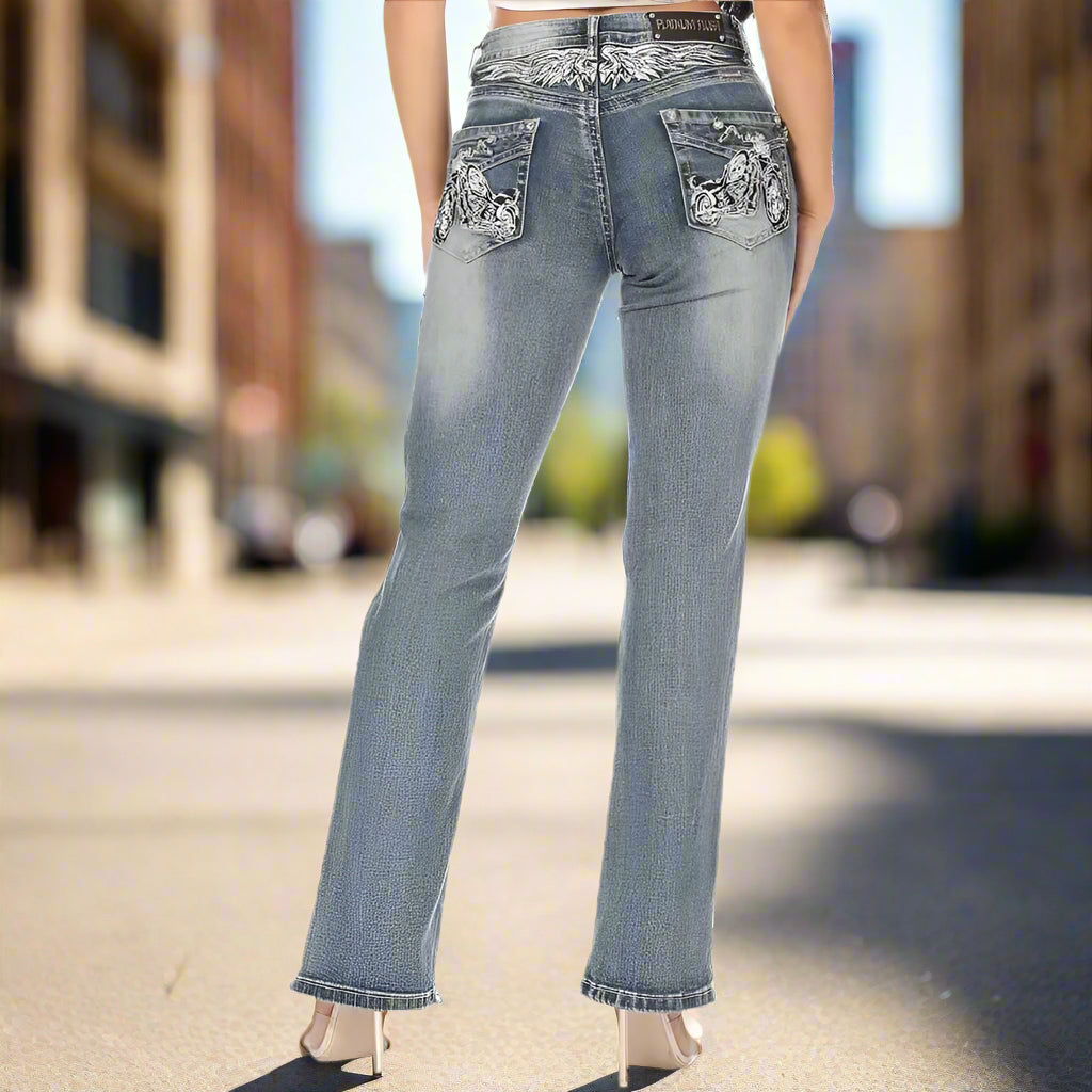 Women's bootcut jeans in blue denim wash with rhinestone pocket detailing