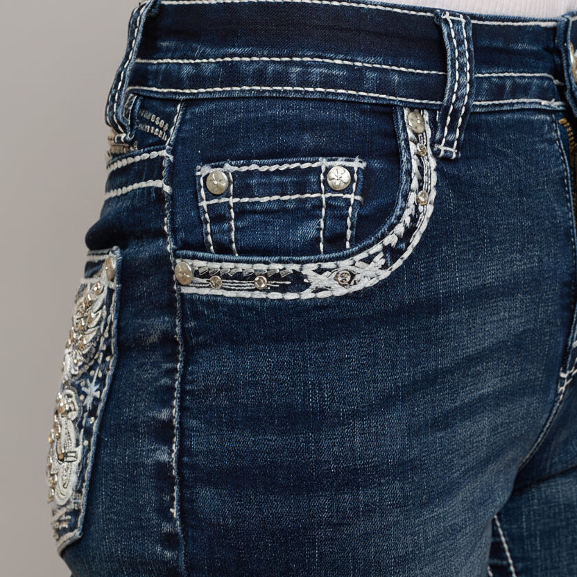 Dark wash denim bootcut jeans with embellished back pocket flap and silver-tone studs