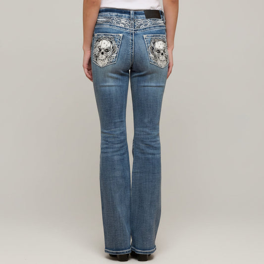 Blue jeans with skull designs on pockets against a plain background