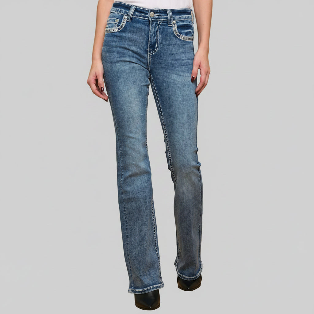 Blue jeans worn by a person on a gray background