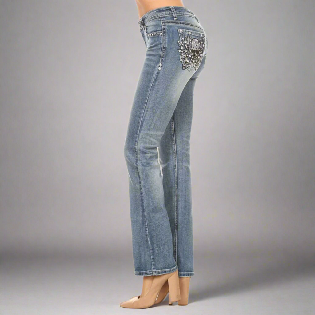 Platinum Plush women's bootcut jeans, side view with rhinestone skull pocket design