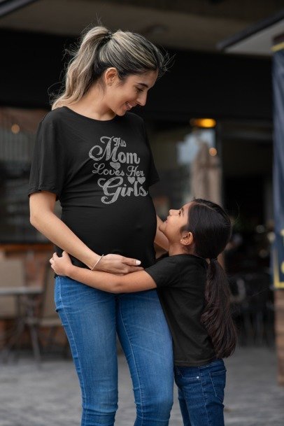 Black crew-neck T-shirt with rhinestone-style "This Mom Loves Her Girls" front